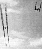 Dramatic view of two A.21A's discharging rocket armament during manoeuvres
