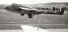 Air-to-air take-off view of an early Vampire 5; mainwheels are just commencing retraction, the nosewheel already locked up and covered.